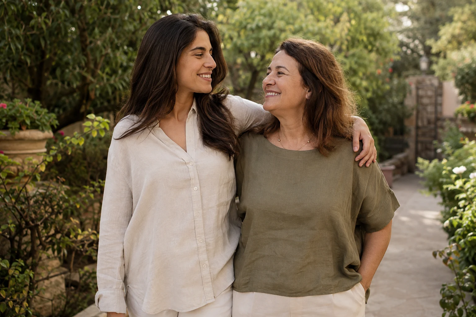 A mother and her adult daughter sharing a quiet walk in a garden